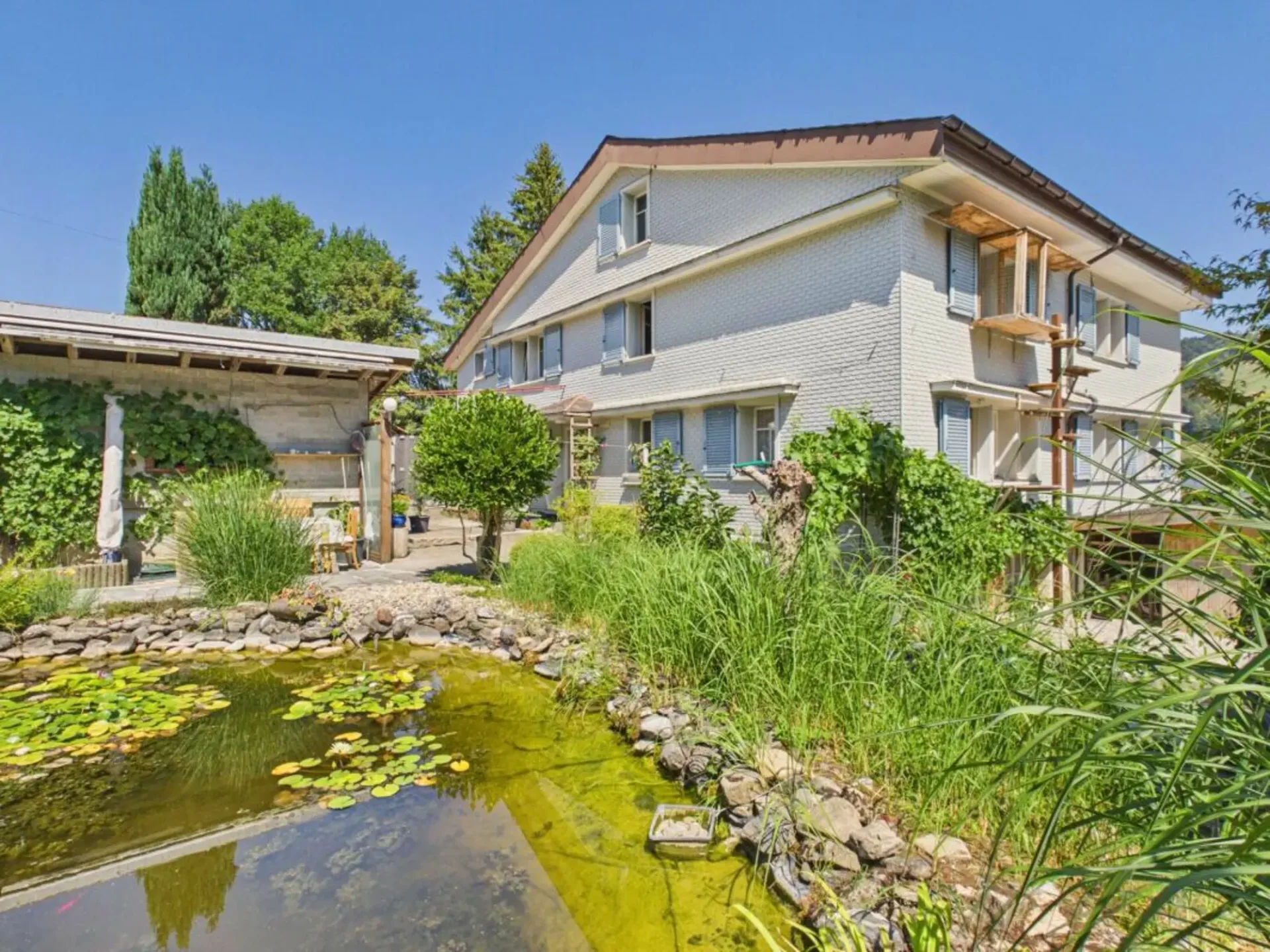 House with large biotope, garage, and two multi-purpose buildings
